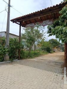 a pavilion with a street sign on a road at Pousada Nosso Cantinho in Guarapari +14 photos