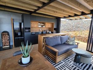 a living room with a couch and a table at Eagle View on Beumont in Dullstroom