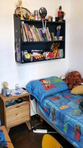 a bedroom with a bed and a desk and a book shelf at Espectacular casa en Olivos in Olivos