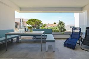 a table and chairs on a balcony with a view at Azuro Novalja Zrce in Novalja