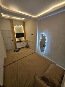a bedroom with a bed and a mirror on the wall at Villa paradise 360 pantai prigi in Tasikmadu