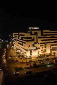 a large building with a parking lot in front of it at Zeta Mall Luxury Apartments by Wall Street Rooftop Pool Access in Islamabad