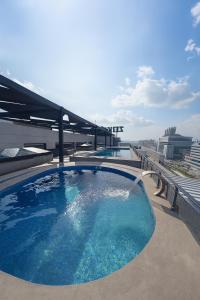 a large swimming pool on the roof of a building at Zeta Mall Luxury Apartments by Wall Street Rooftop Pool Access in Islamabad