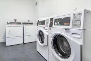 three washing machines and a washer and dryer in a room at Oceanfront Penthouse with Intercoastal Views in Hollywood Beach +26 photos