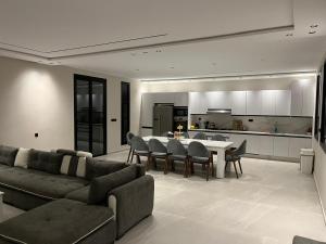 a living room with a couch and a table and a kitchen at Houseselect in Nador