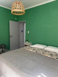 a bedroom with two beds and a green wall at Las Moras saladillo in Saladillo