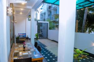 a patio with a table and chairs in a building at Ocean Light Mirissa in Mirissa