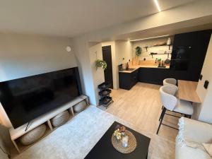 an overhead view of a living room with a large flat screen tv at Notodden Luxe two-bedroom Apartment in Notodden