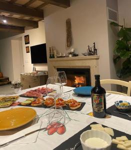 een tafel met borden en een fles wijn bij Poderino - a place to feel in Cento