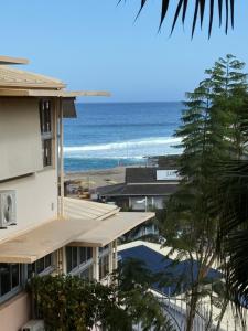 a view of the ocean from a building at Studio Piscine à Saint-Gilles prés des plages in L'Ermitage-Les-Bains