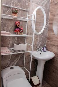 a bathroom with a toilet and a sink and a mirror at Valle Sagrado Mágico in Urubamba