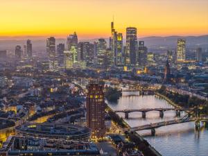 a city skyline with a river and a bridge at Main Plaza Suite Tower in Frankfurt/Main