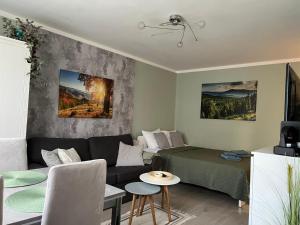 a living room with a couch and a bed at Apartament Piaskowa Mountain & Coffee in Wałbrzych