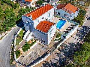 an overhead view of a house with an orange roof at MY DALMATIA - Sea view villa Anpero with private heated pool and sauna in Maslenica
