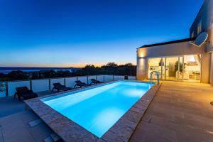 a swimming pool on the roof of a house at MY DALMATIA - Sea view villa Anpero with private heated pool and sauna in Maslenica