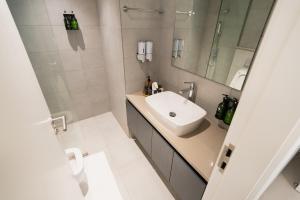 a bathroom with a sink and a mirror at One bedroom apartment in Sharjah by Stay Bnb in Sharjah +7 photos