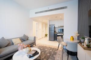 a living room with a couch and a table at One bedroom apartment in Sharjah by Stay Bnb in Sharjah