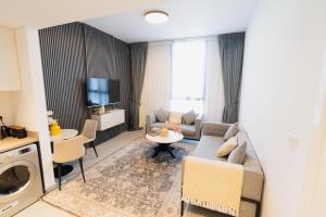 a living room with a couch and a table at One bedroom apartment in Sharjah by Stay Bnb in Sharjah