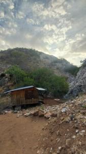 a building on the side of a mountain at Glocke Mountain Camp in Outjo