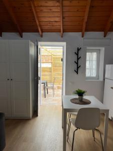 a kitchen and dining room with a table and chairs at Moya senderos, naturaleza y mar 2 in Moya