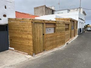 a wooden fence on the side of a house at Moya senderos, naturaleza y mar 2 in Moya