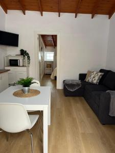 a living room with a couch and a table at Moya senderos, naturaleza y mar 2 in Moya