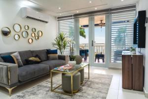a living room with a couch and a table at Isla Apartment in Ocean Club Rincon in Corcega +16 photos