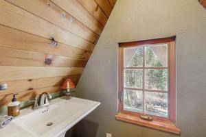 a bathroom with a sink and a window at Serene Lakes Splendor in Soda Springs