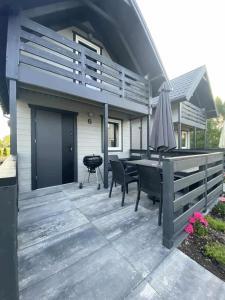 a patio with a table and chairs and a grill at Sister's House Zator in Zator