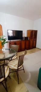 a dining room with a glass table and chairs at Apartamento - Centro Itapuã - 1Q in Vila Velha