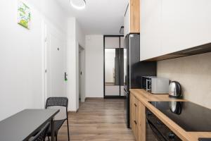 a kitchen with a table and a counter top at Pokoje Warszawski Świt in Warsaw