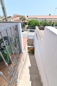a view of a balcony with stairs and a railing at IzzHome Sea Style Room in Pula