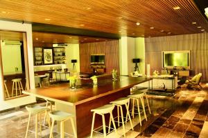 a kitchen with a large island with bar stools at Consulado USA en Merida in Xcumpich