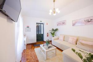 a living room with a couch and a table at Peaceful Panorama by YOUR KEY MADEIRA in Porto Moniz