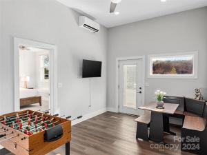 a living room with a foosball table and a couch at French Broad Overlook in Asheville