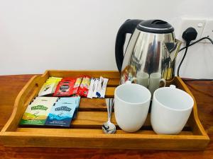 a tray with two cups and a coffee pot on a table at Seavora Tangalle in Tangalle