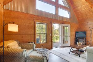 a living room with a couch and a tv at Hike and Unwind, Peaceful Wooded Retreat in Newport in Newport
