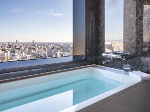 a bath tub with a view of a city at Mitsui Garden Hotel Nagoya Premier in Nagoya +49 photos