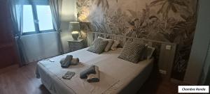 a bedroom with a bed with shoes on it at Oasis de Bornos Maison Entière in Bornos +43 photos