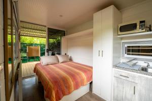 a small bedroom with a bed and a sink at Casa Playa Avellanas in Playa Avellana