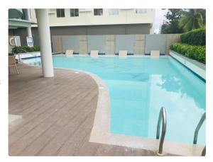 a large blue swimming pool in a building at The Lotus Suite2 Iloilo in Iloilo City