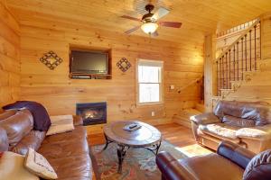 a living room with leather furniture and a fireplace at Decks and Panoramic Views Rustic Sparta Cabin in Sparta