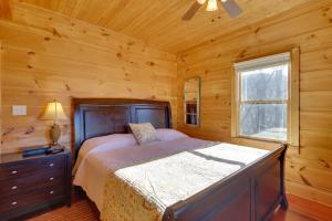 a bedroom with a bed in a log cabin at Decks and Panoramic Views Rustic Sparta Cabin in Sparta