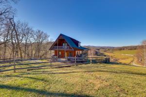 a small house in a field with a fence at Decks and Panoramic Views Rustic Sparta Cabin in Sparta