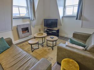 a living room with a couch and a fireplace at Sauna Zee 27H in Colijnsplaat