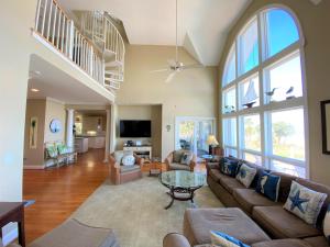 a living room with a couch and a table at Lookout Point in Edisto Island