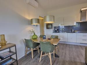 a kitchen and dining room with a table and chairs at Sauna Zee 27H in Colijnsplaat