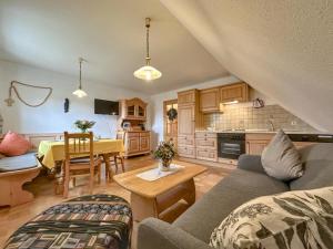 a living room with a couch and a table at Blumenhof in Dietersdorf