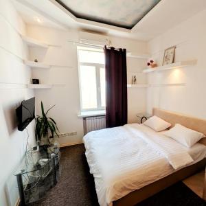 a bedroom with a bed and a window at Kyiv Sky Apartment in Kyiv