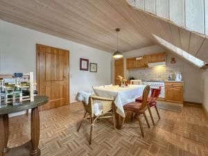 a kitchen with a table and chairs in a room at Weiherblasch II in Dietersdorf